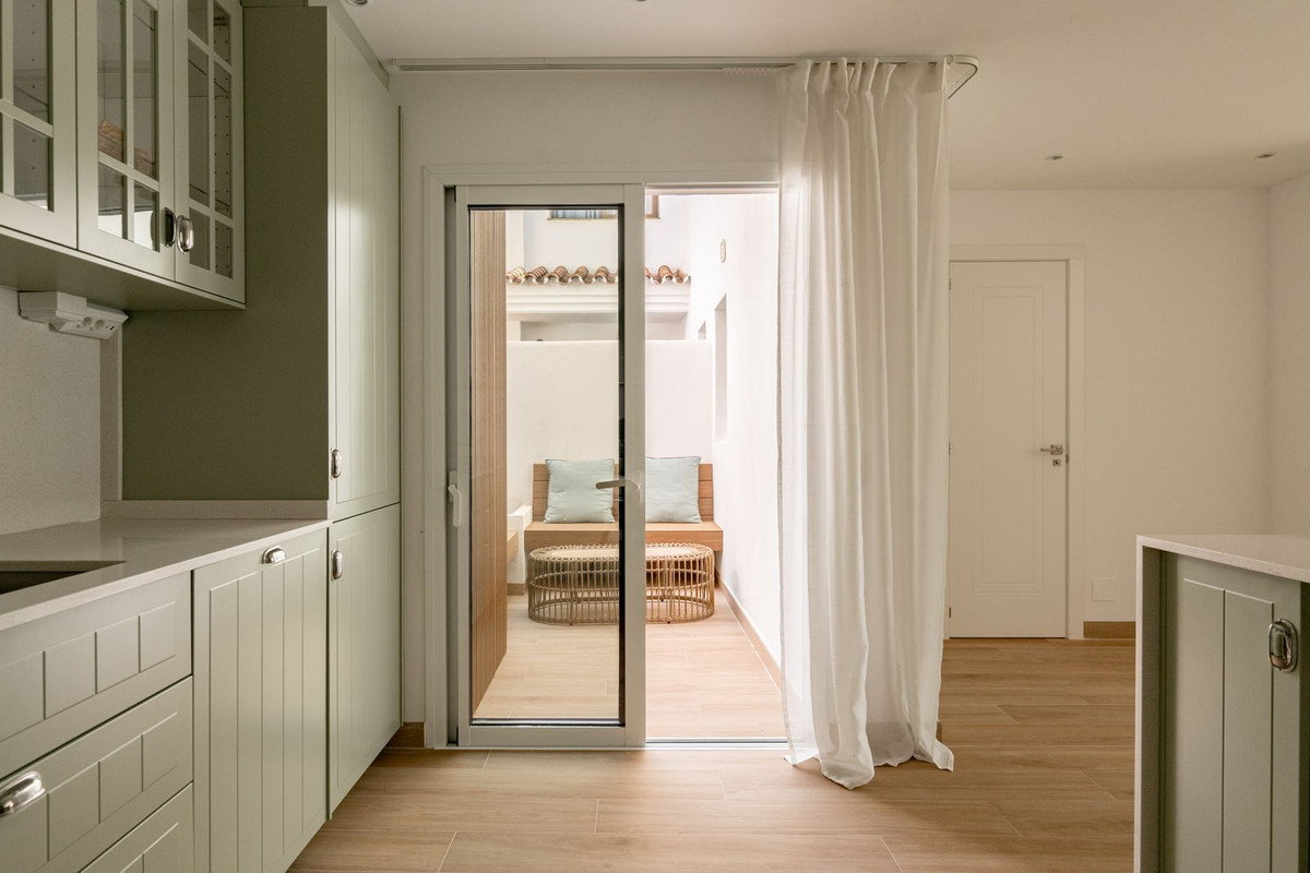 Built-in lounge seating with cushions in the small private English patio