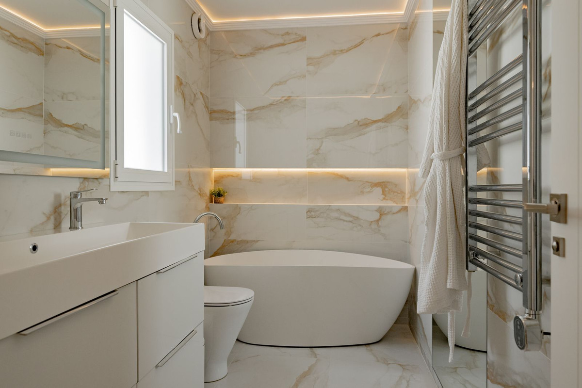 Bathroom with freestanding oval bathtub and recessed lighting